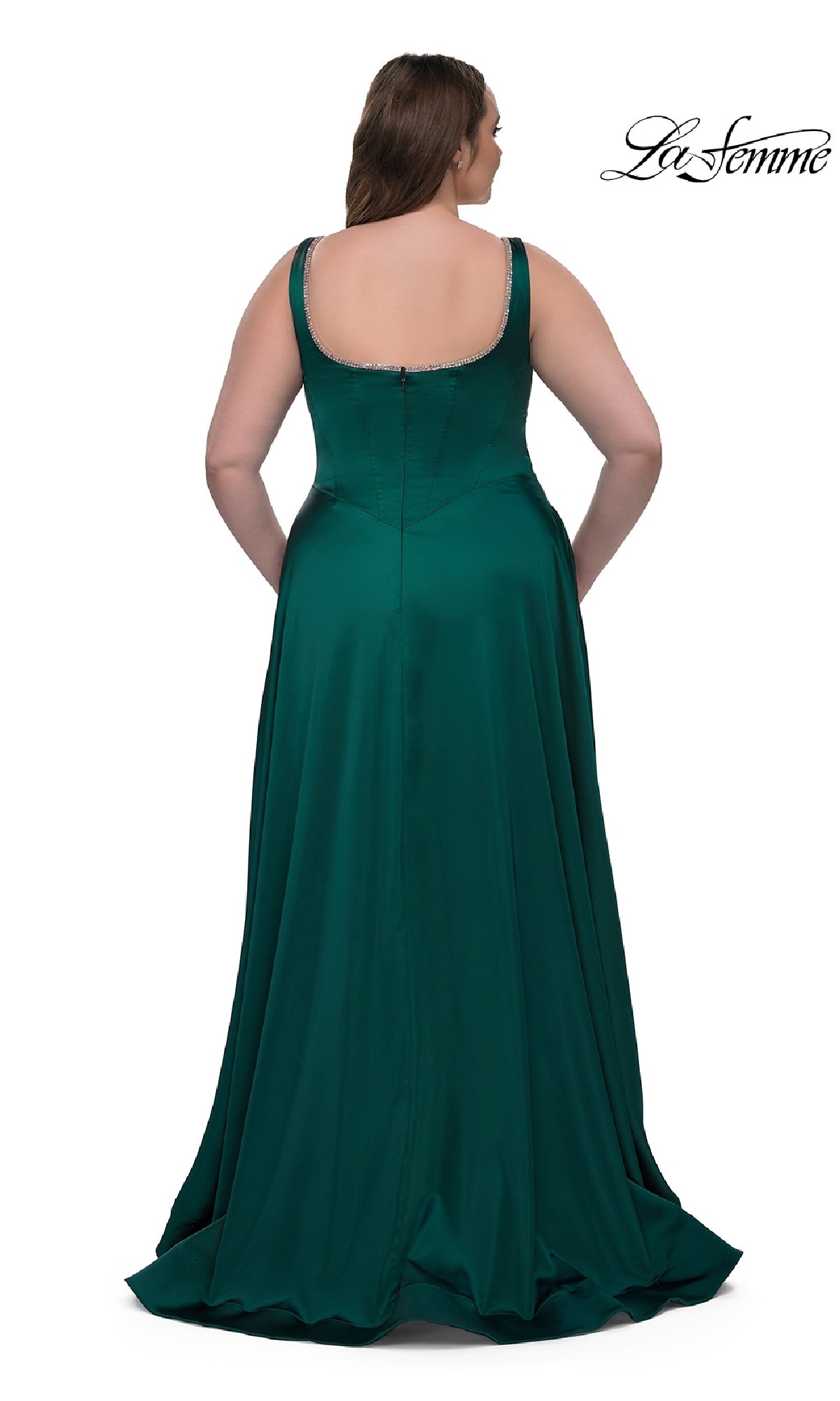 A woman faces away, wearing the plus-size La Femme 33026 classic long prom gown in emerald green, featuring a floor-length, sleeveless design with a scoop back and subtle beaded trim, set against a plain white background.